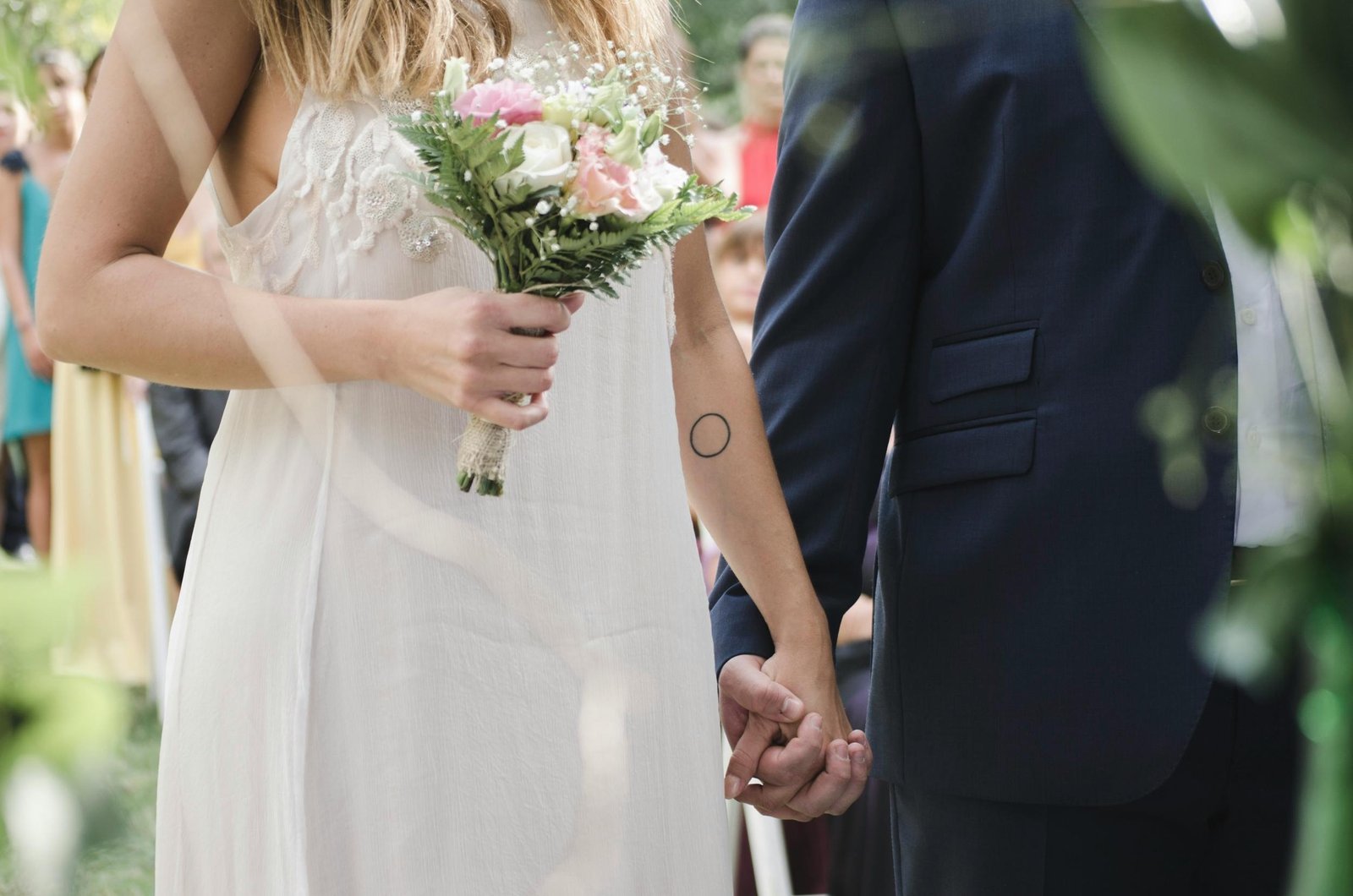 Couple kissing under circular floral arch